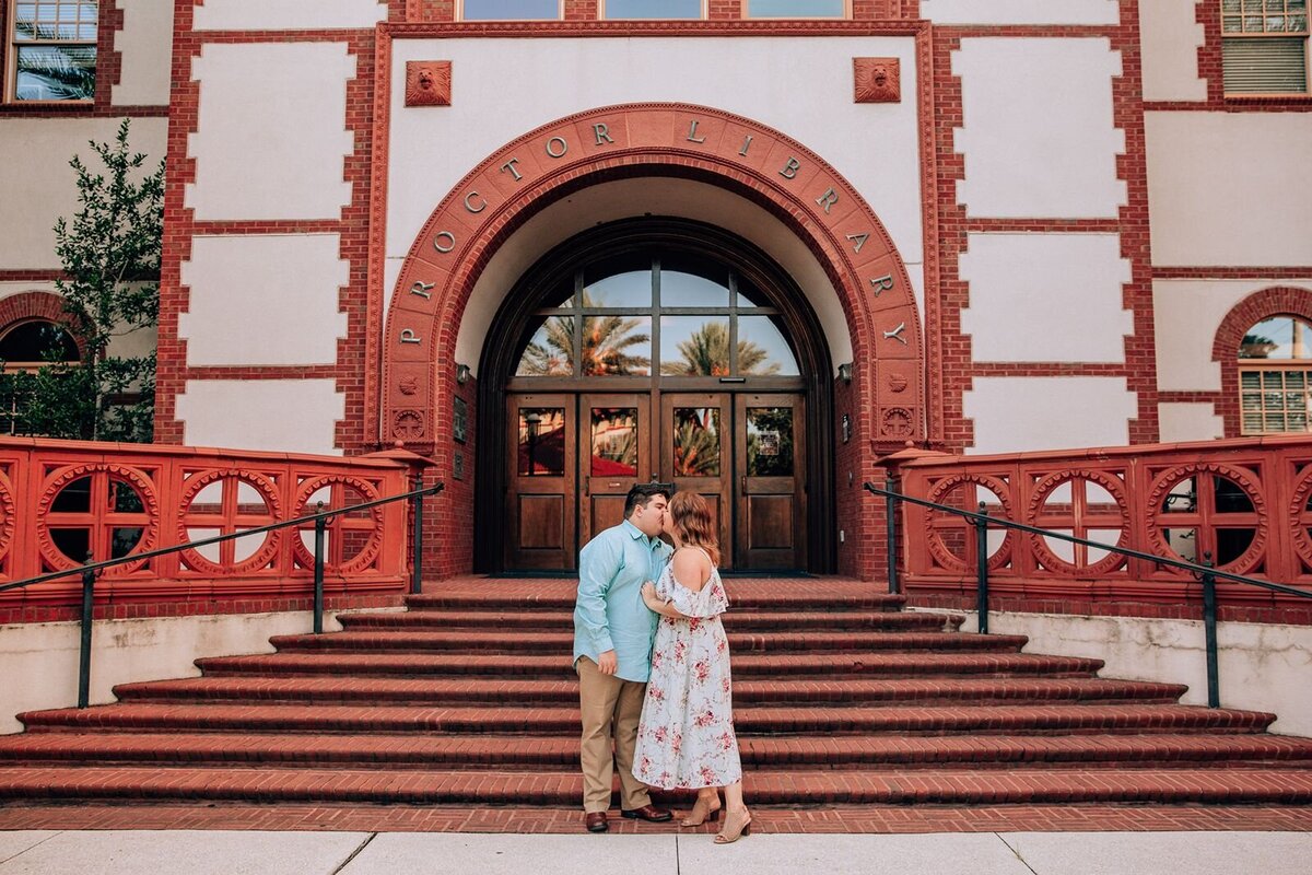 couple kisses in front of an old building in st. augustine florida