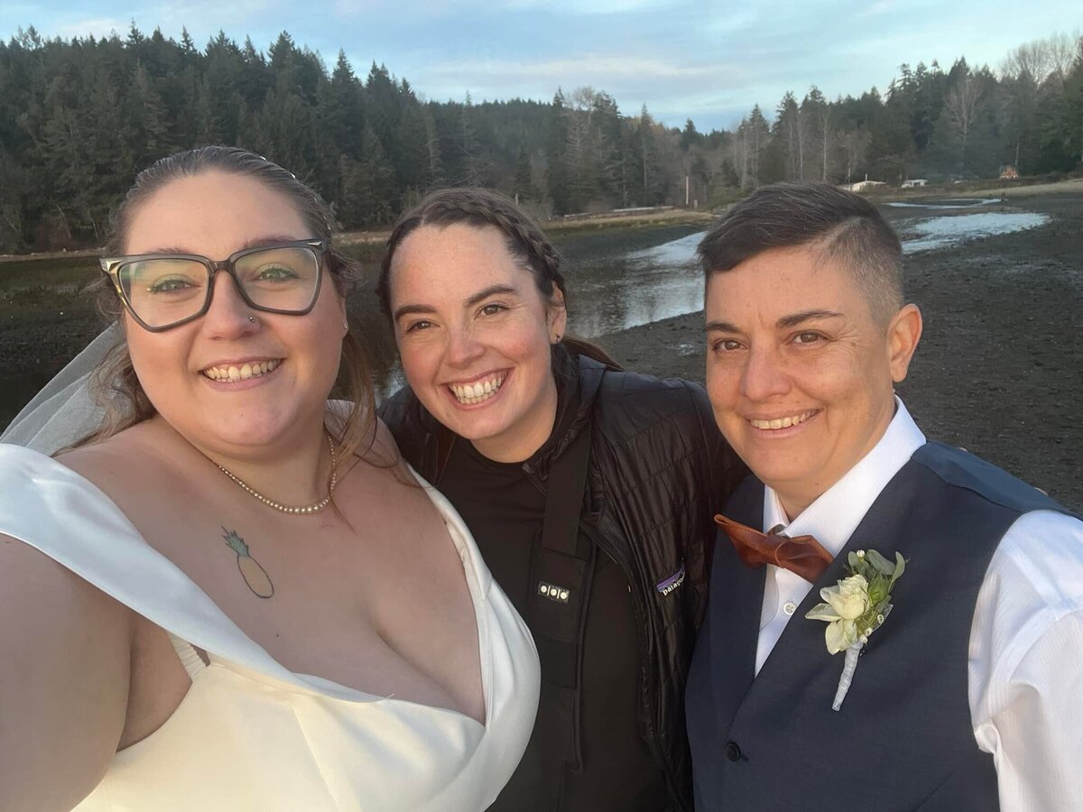 LGBTQ Couple taking a selfie with photographer after elopement