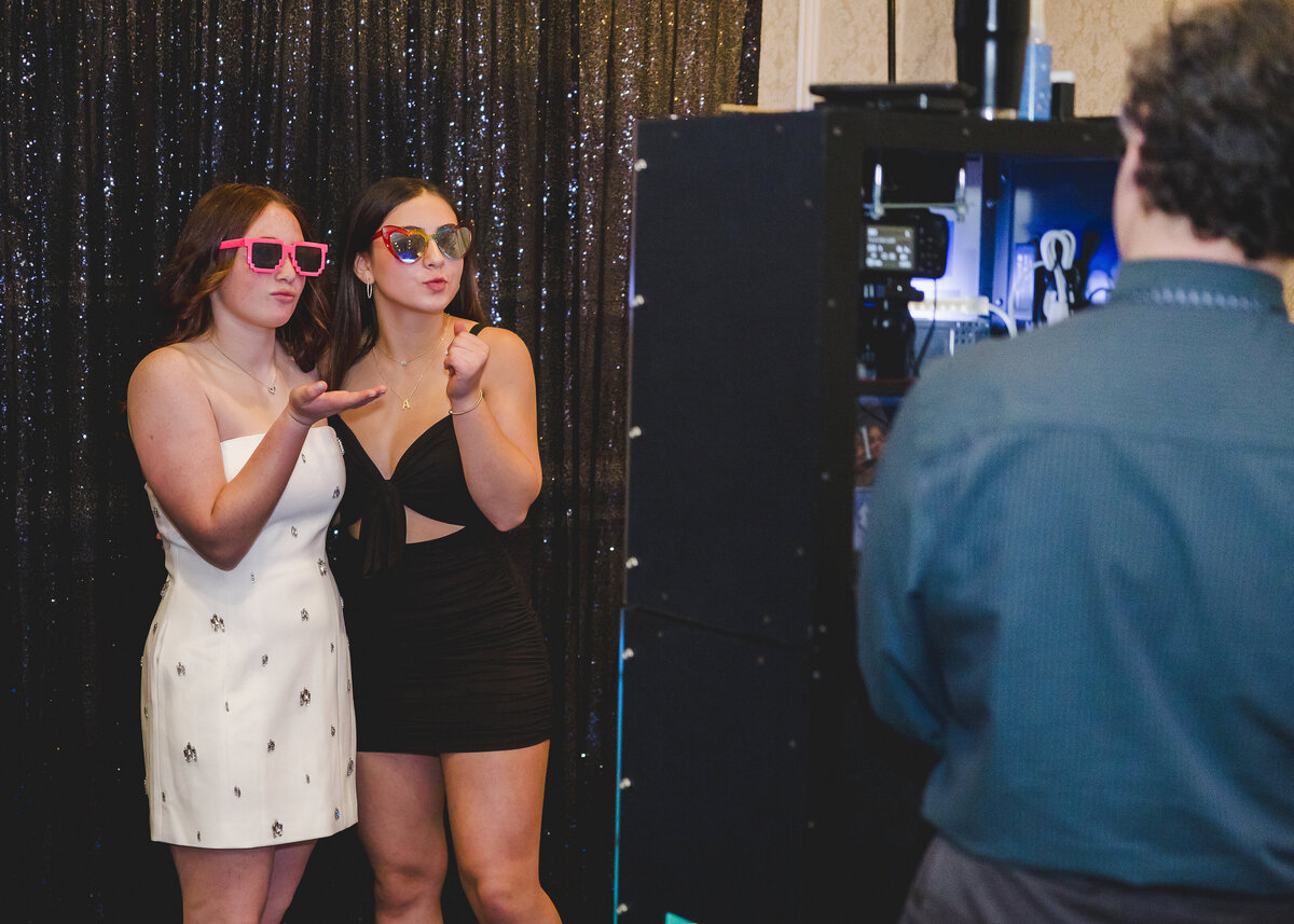 Behind the scenes photo of girls posing at a photo booth at a Bat Mitzvah party in Union County, NJ