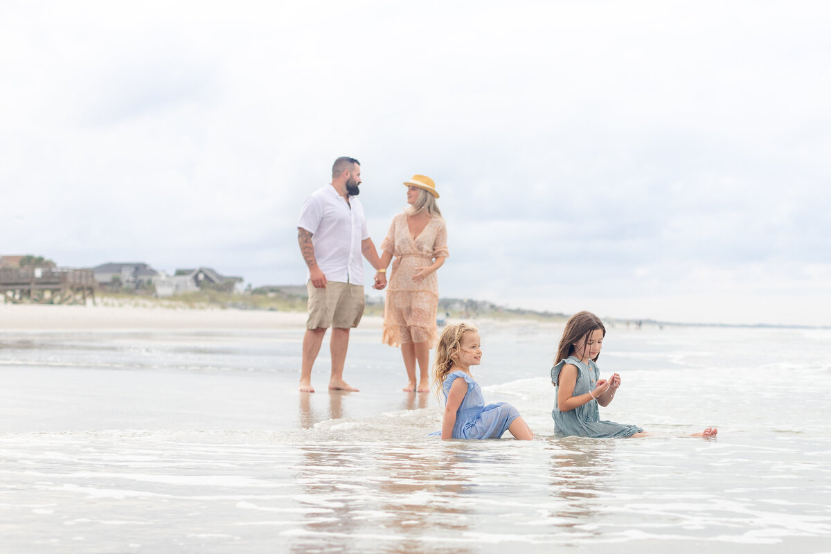 Family of four playing in the ocean during a family session in Ponte Vedra Florida