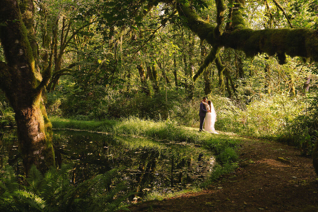 A bride and groom embrace outdoors ah The Thyme Garden in Oregon.