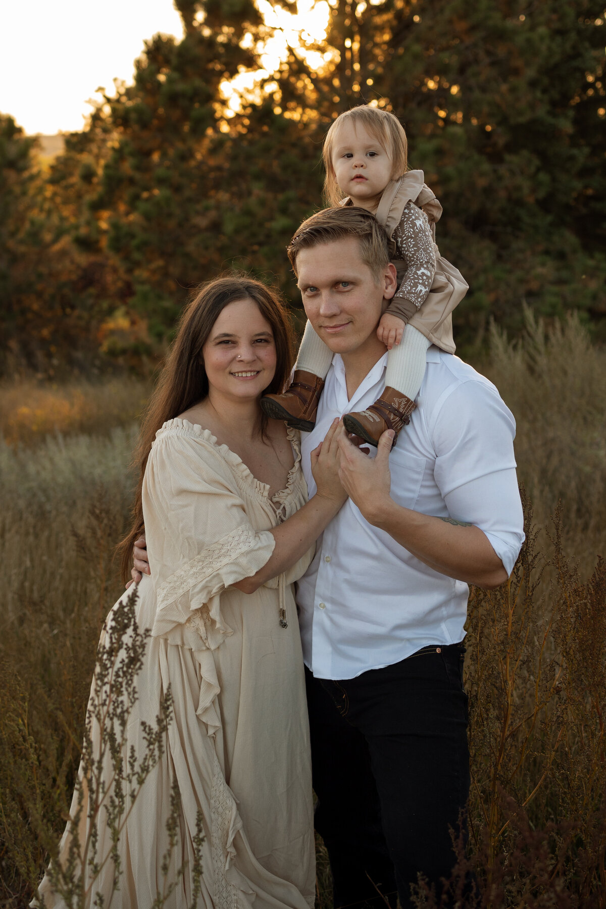 Minot newborn photographer and family smile for their session.