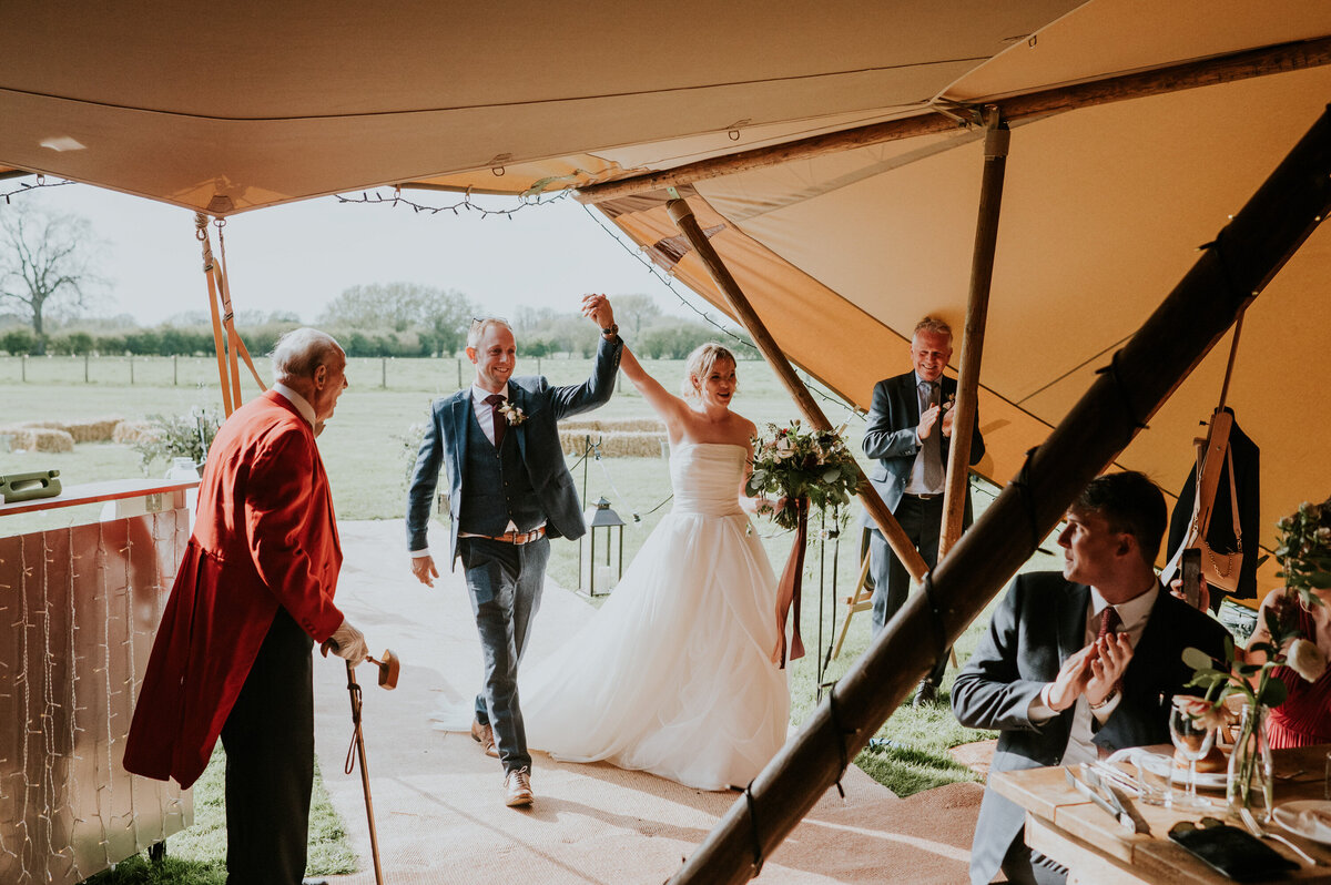 Bride and Groom being announced into tipi wedding breakfast