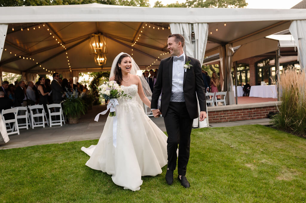 Bride and groom walk out of ceremony tent in Skokie, IL