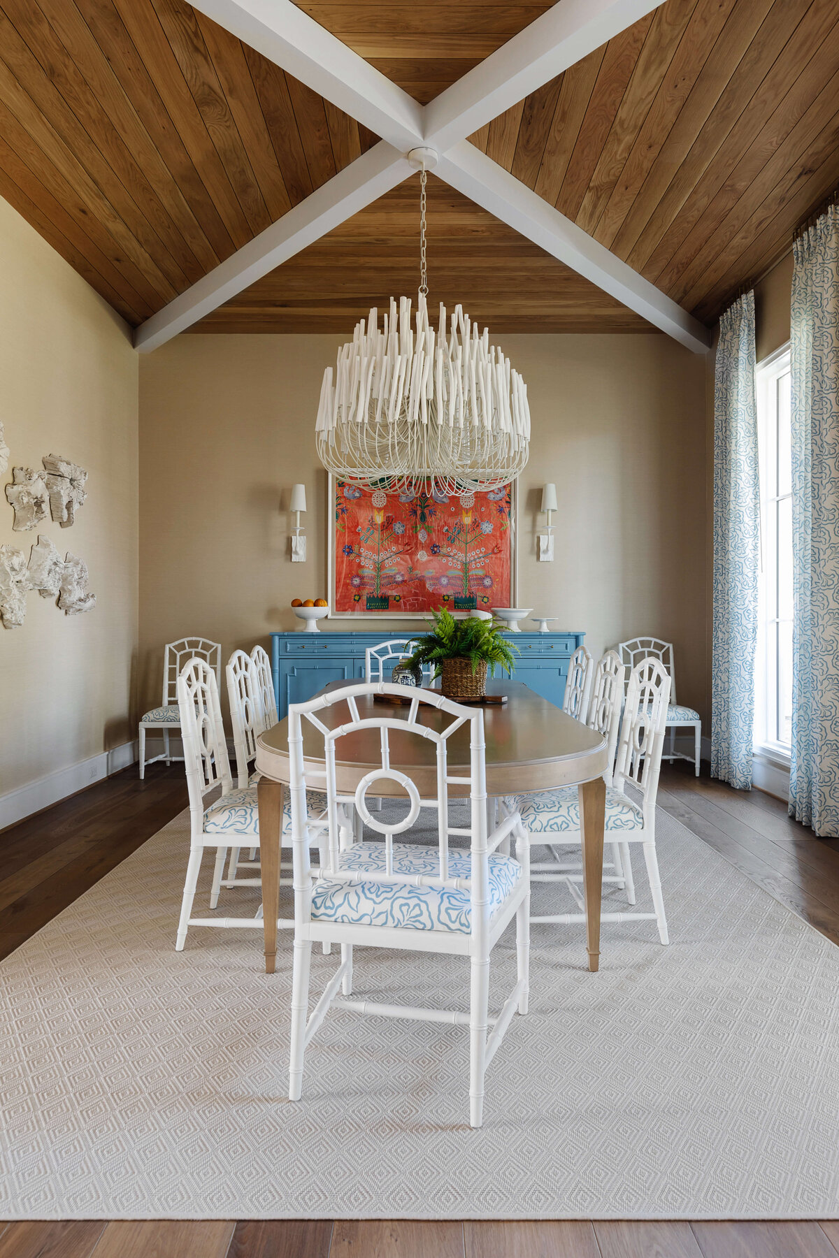 oyster creek studios memorial new build white cahirs around a wooden dining room table with chandelier in dining room