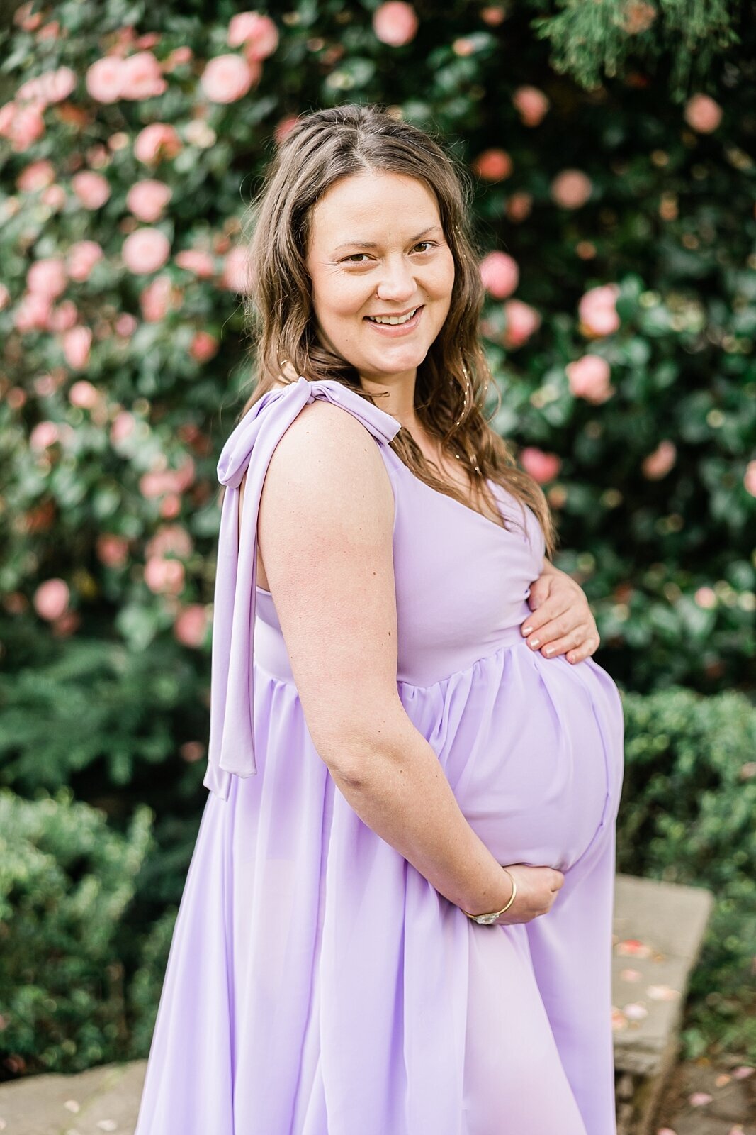 smiling mom in purple maternity gown in portland park