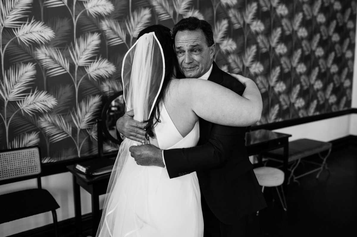 emotional hug father and daughter at wedding