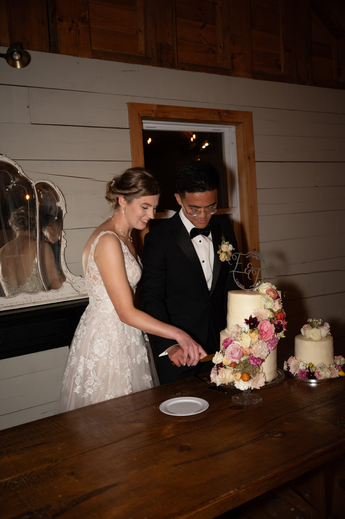 A wedding couple cutting their cake together