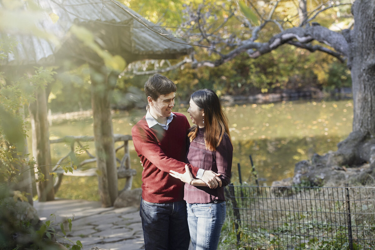 A couple with their arms around each other in a garden