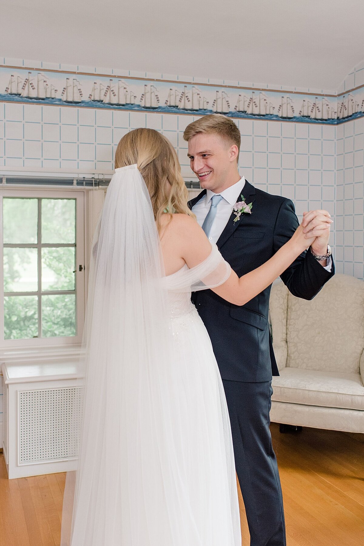 Groom embraces bride during first look at Beverly Mansion in Columbus, Ohio
