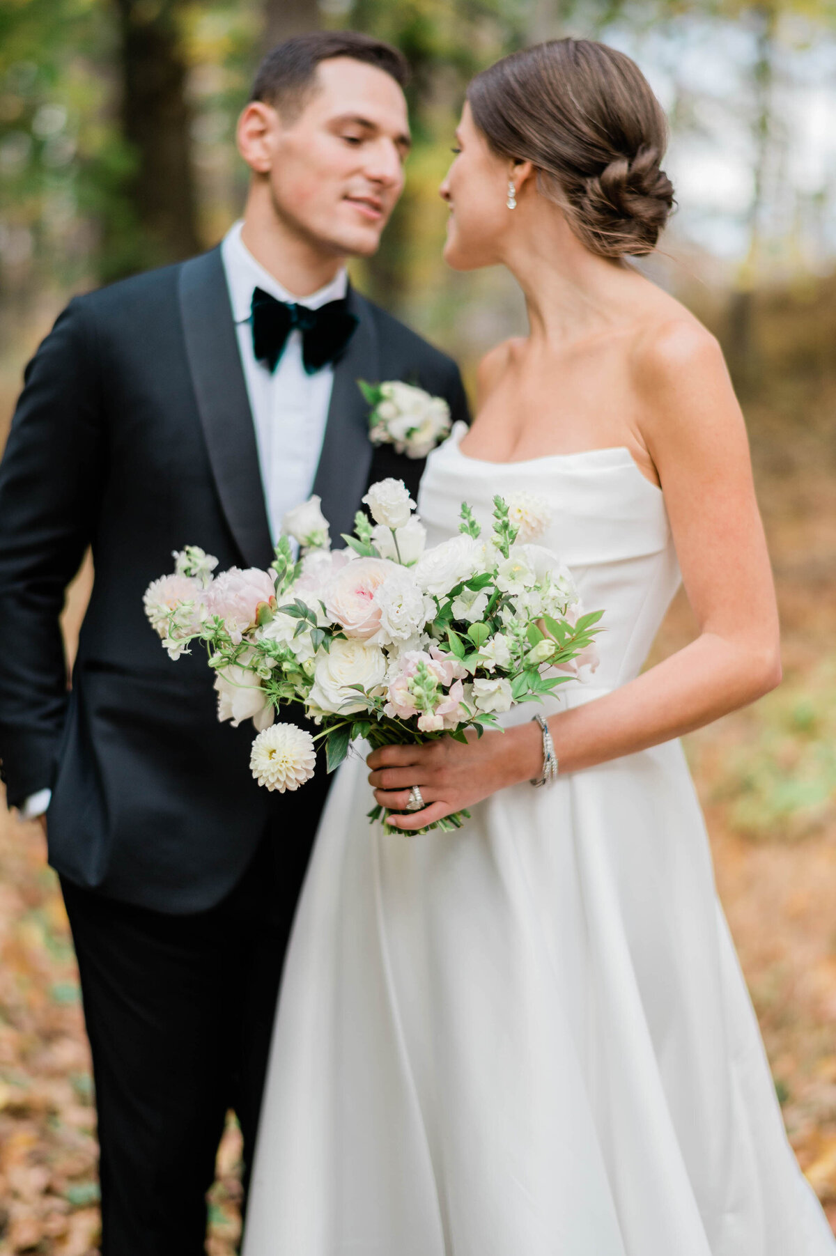 A newlywed couple shares an intimate moment in a wooded area at Meadow Ridge on Hudson in Hudson, NY