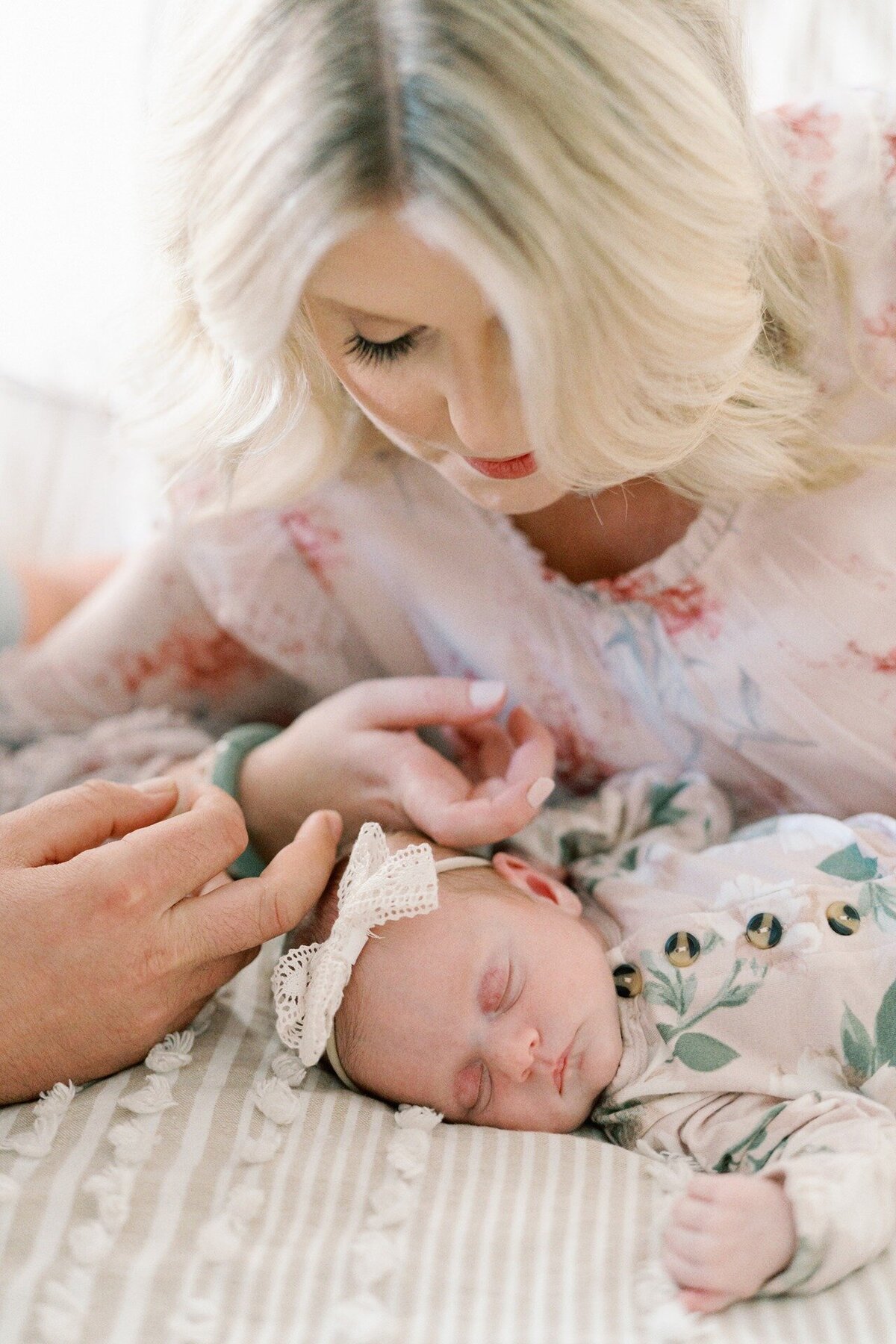mom-and-dad-gently-stroking-newborns-hair