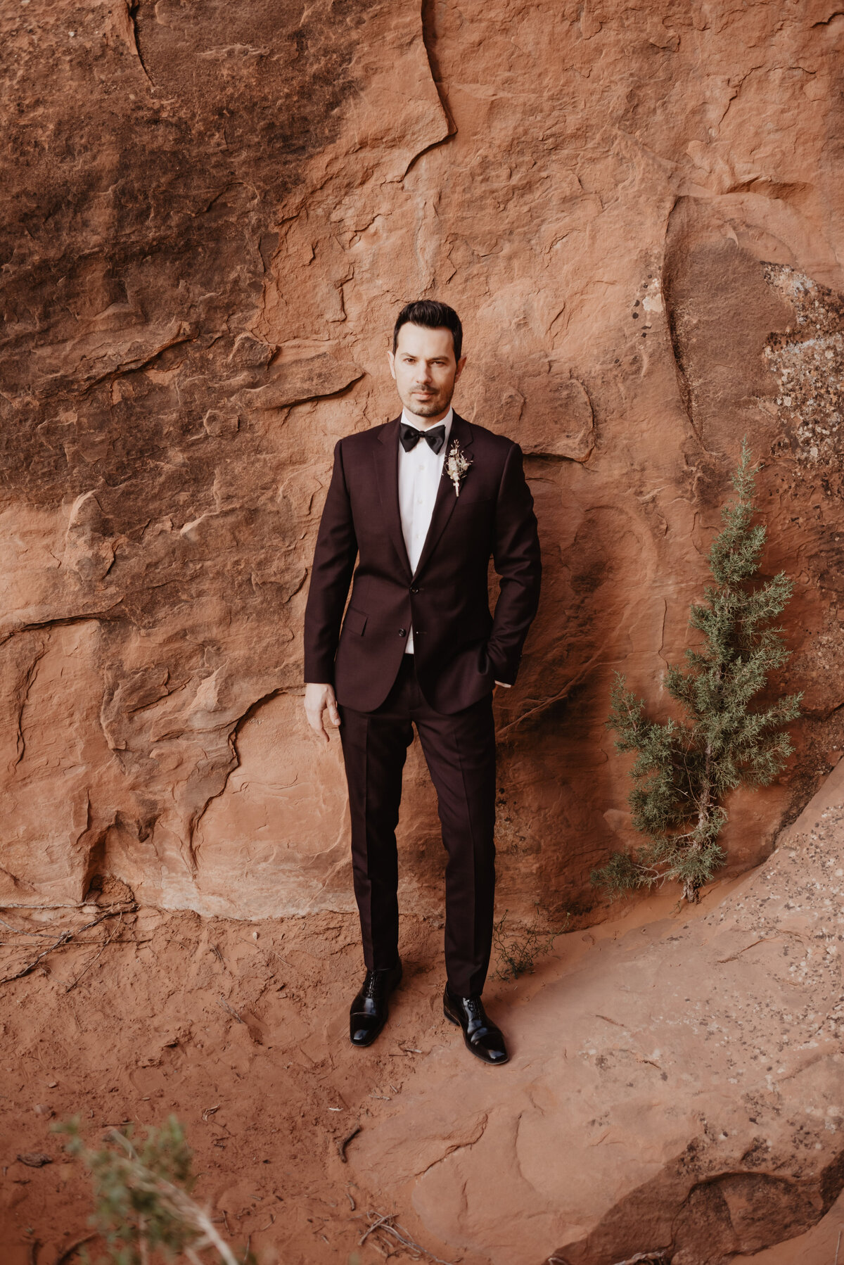 Utah elopement photographer captures groom smiling during groom portraits
