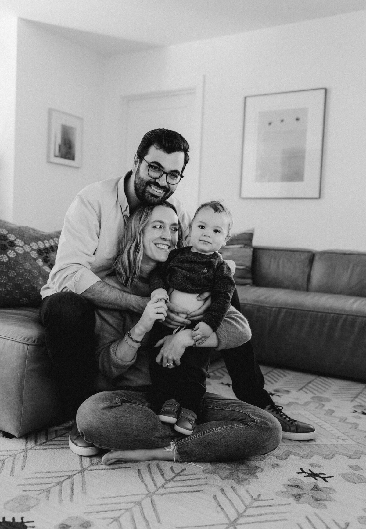 Mother and father sitting on floor with toddler at Austin family photo session