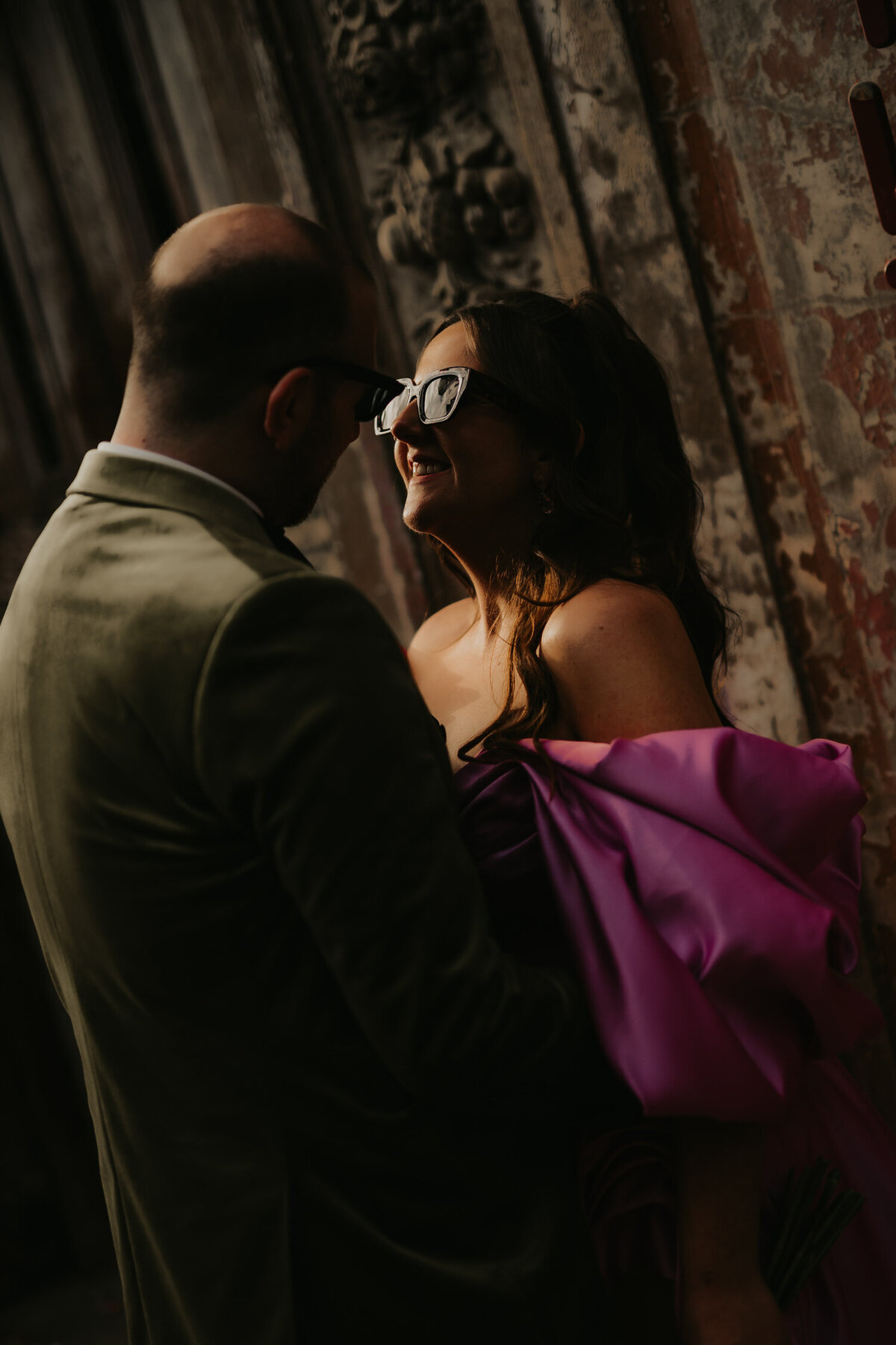 Bride and Groom pose outside Wilton's Music Hall. 