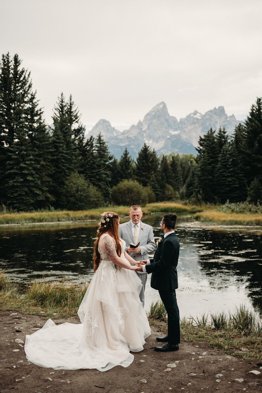 Couples elopes in front of Grand Tetons at Schwabacher Landing