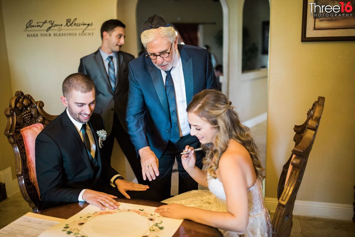 Bride and Groom sign their contract