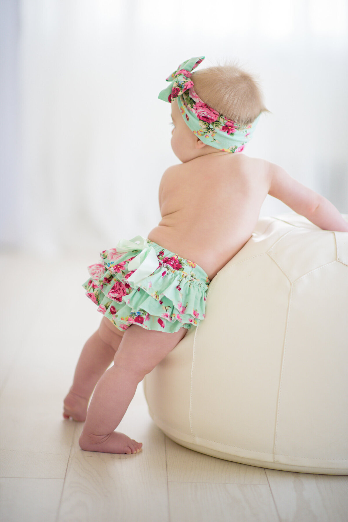 Baby staning in Boise photo studio.