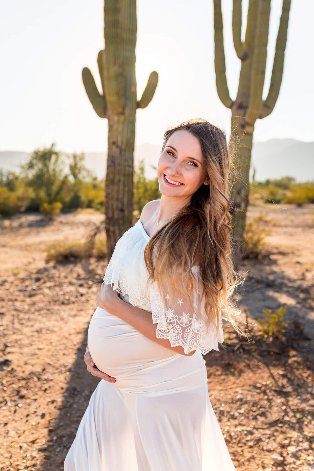 mom smiling for maternity portrait in Arizona