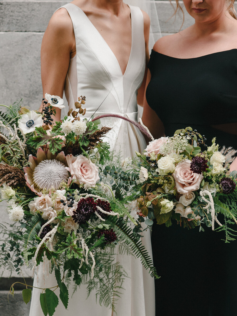A bride holds an organic cascading bouquet at a Montreal wedding.