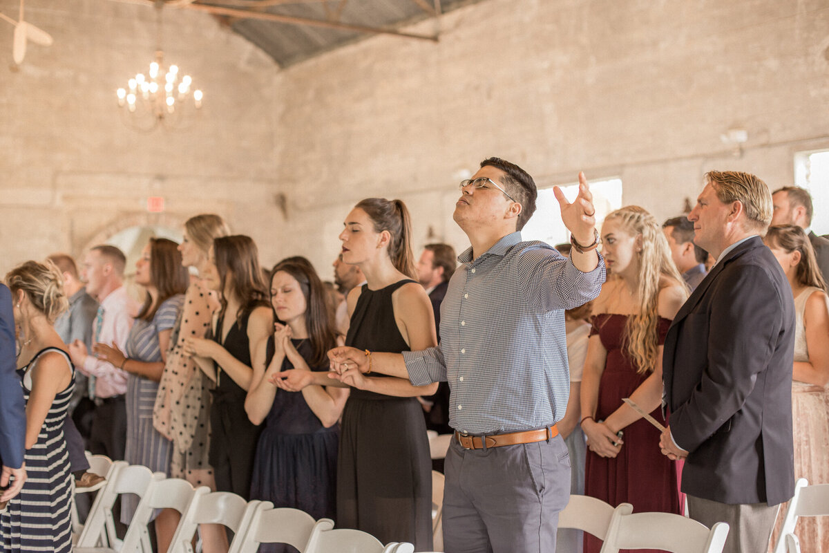 Guests enjoying the ceremony, celebrating the marriage of the bride and groom.