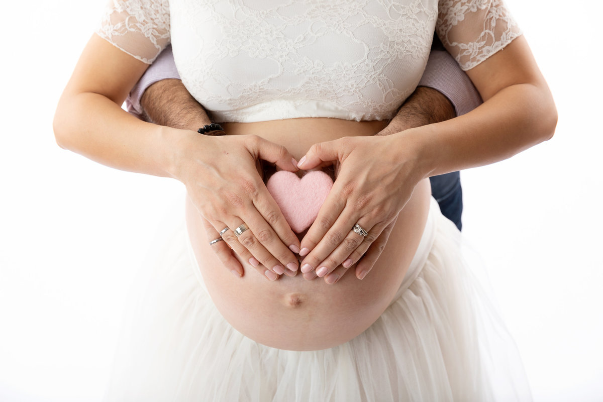 Mom and dad holding heart