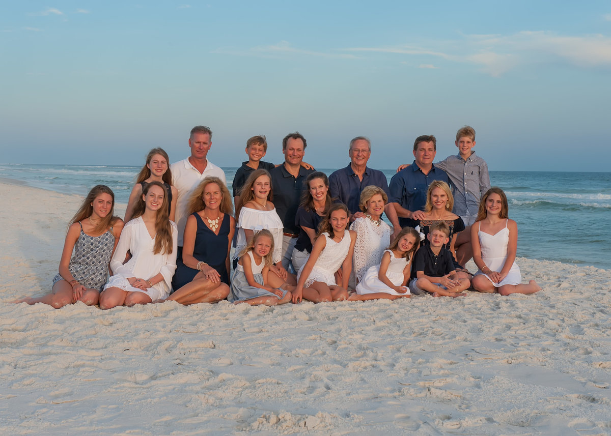 large extended family photographed sitting on the beach in Rosemary on 30a