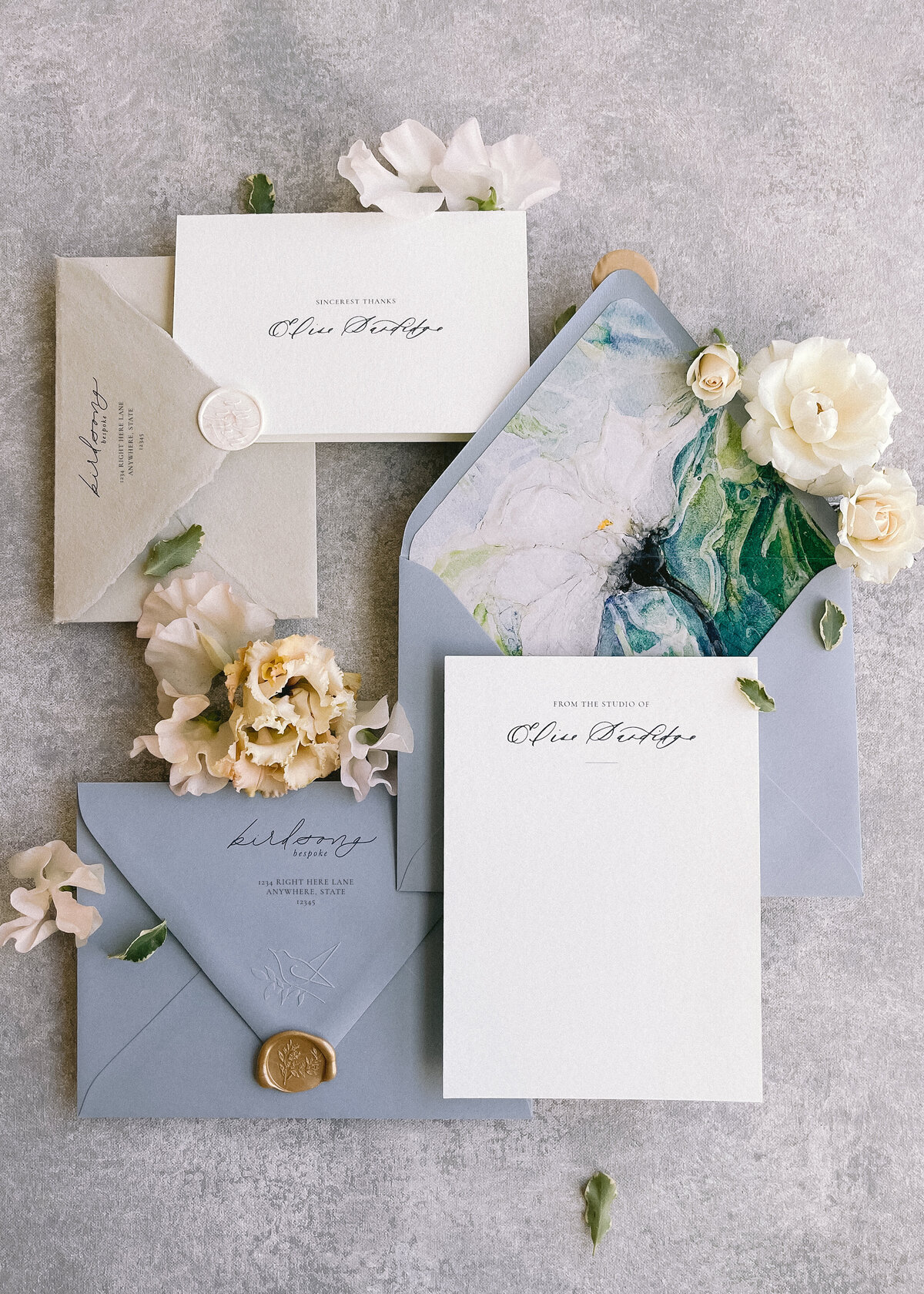 Custom business stationery including handwritten calligraphy and a watercolor envelope liner