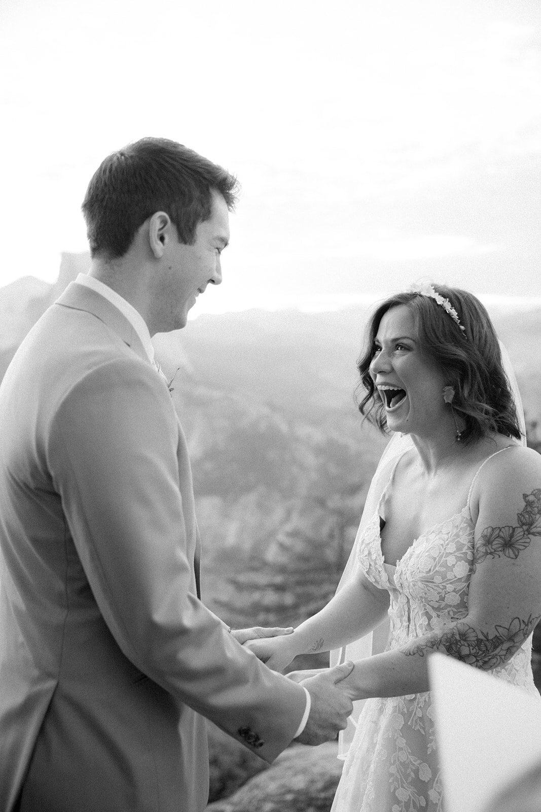 Bride and groom laugh together in glee after having said their wedding vows during their elopement in California. 