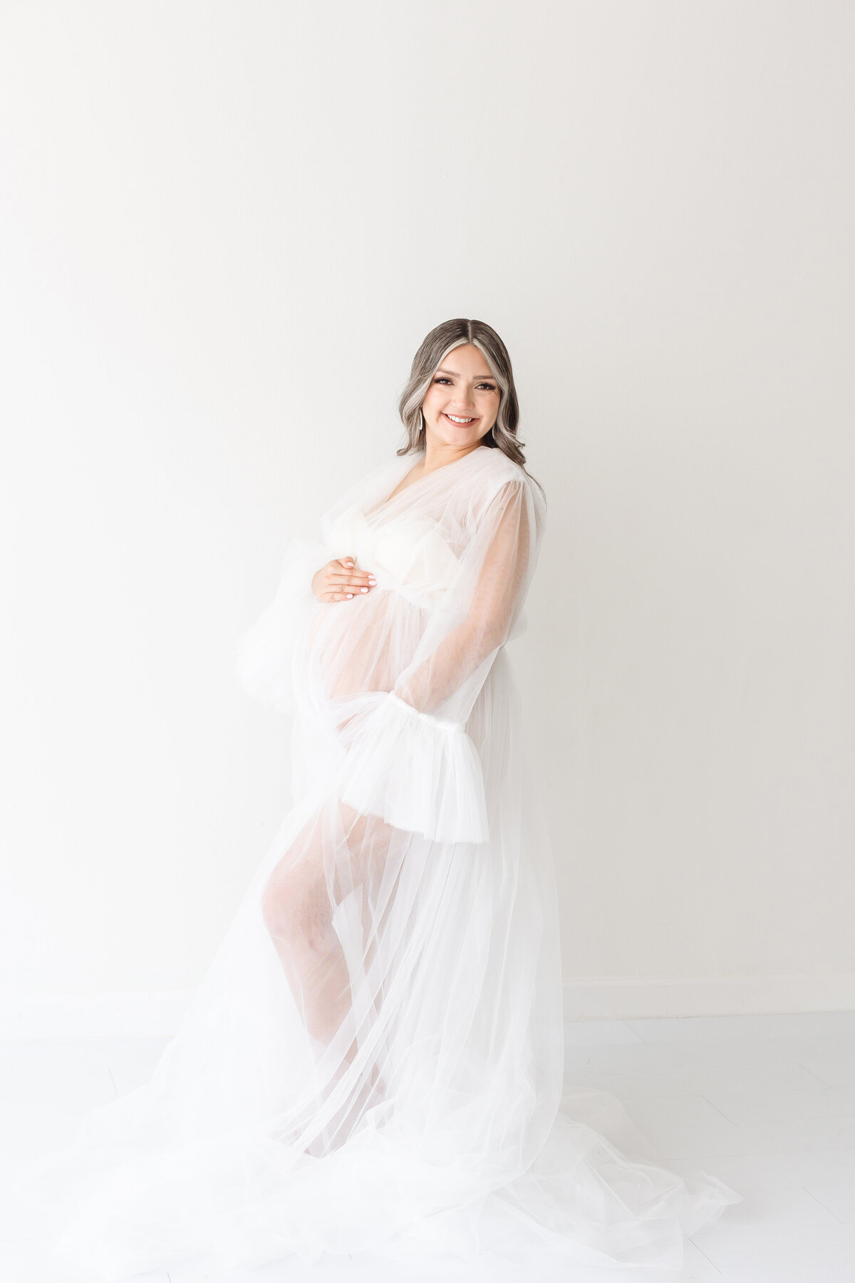 smiling lady holding belly