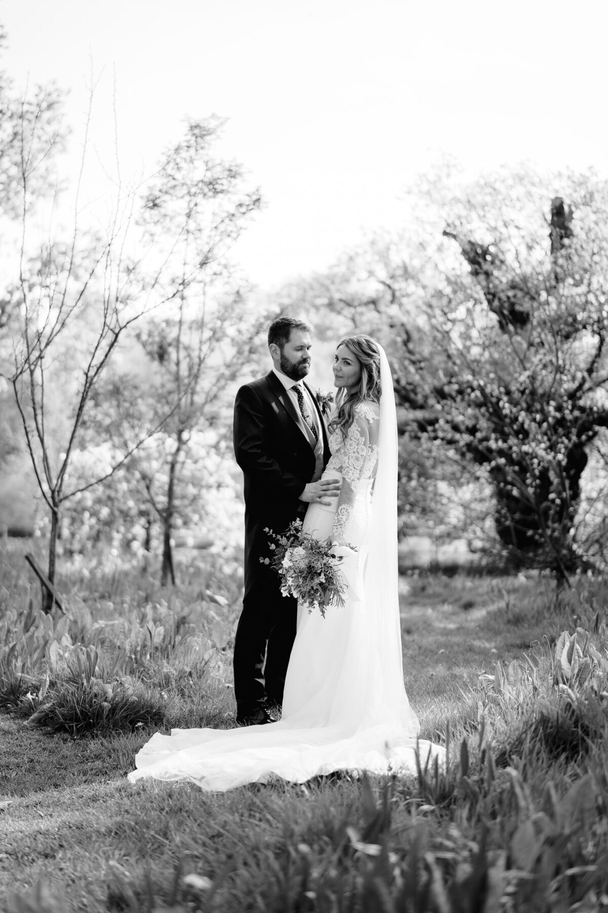 Bride and groom stood in the grounds of Iscoyd Park in black-and-white