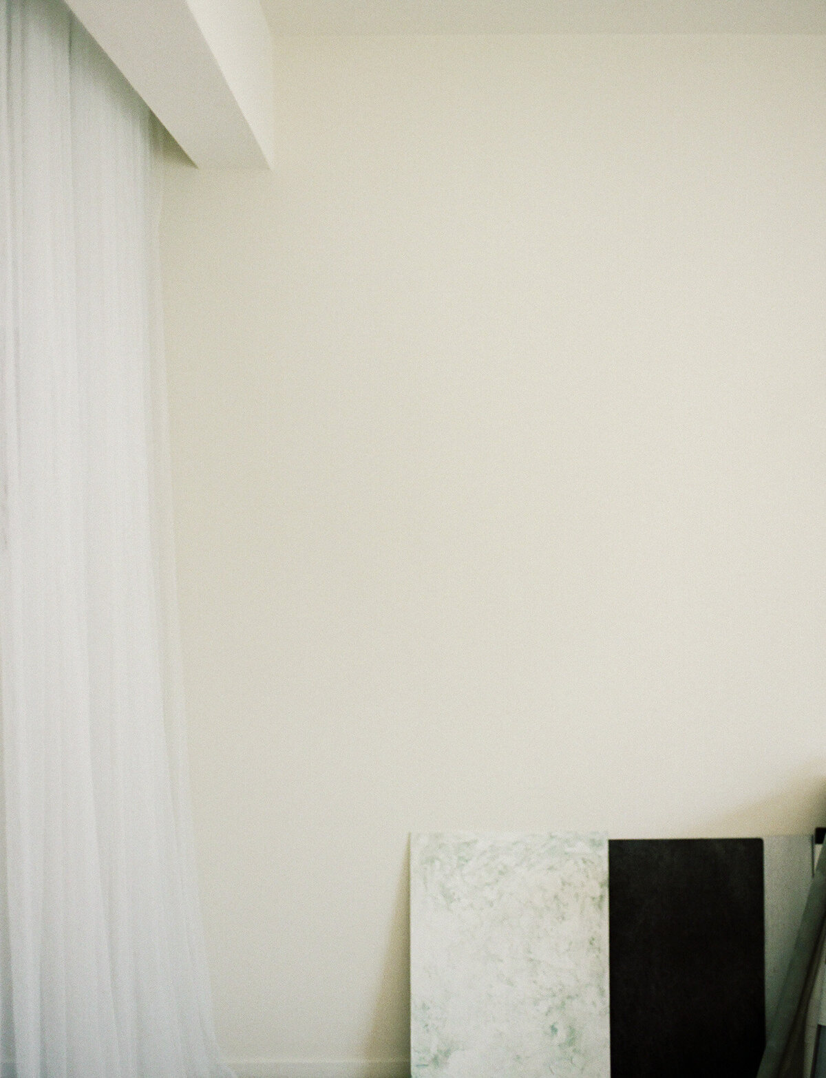 photographer studio apartment workspace, ethereal white space, sheer curtains, painterly styling boards