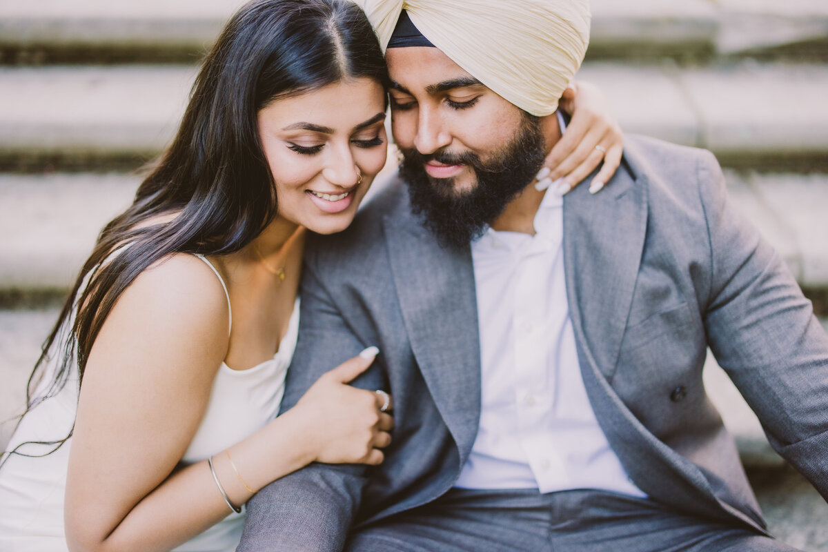 A sikh couple share a moment sitting on the steps at nj botanical garden at ringwood state park