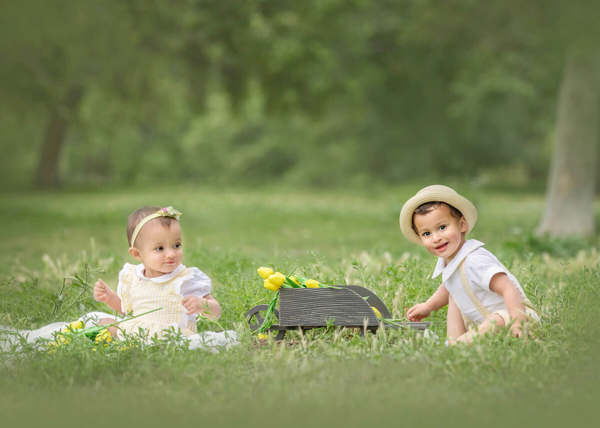 Toddler sister and brother with spring flowers at the park - Los Angeles Children’s Photographer
