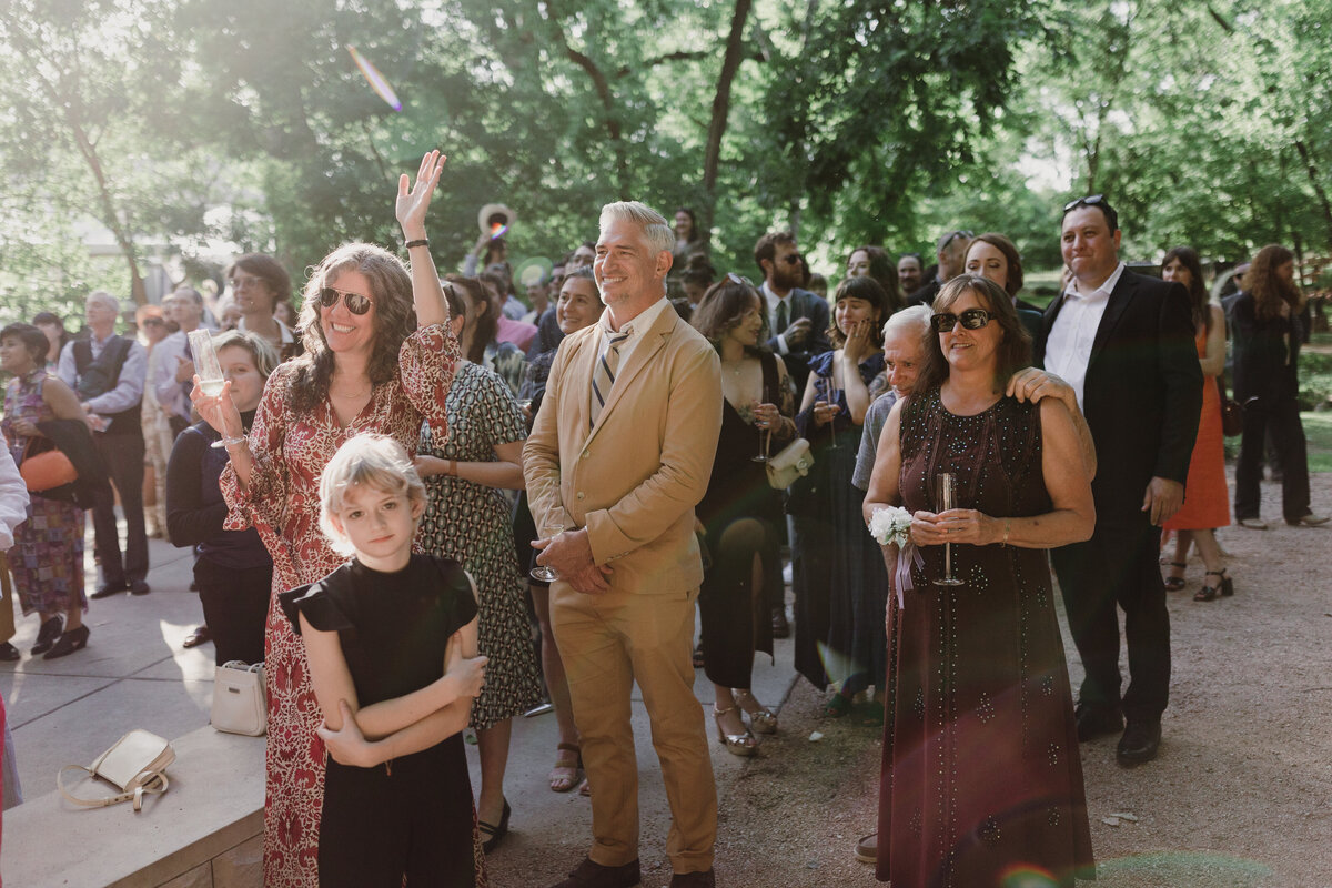 Wedding guests witnessing wedding at Umlauf Sculpture Garden, Austin
