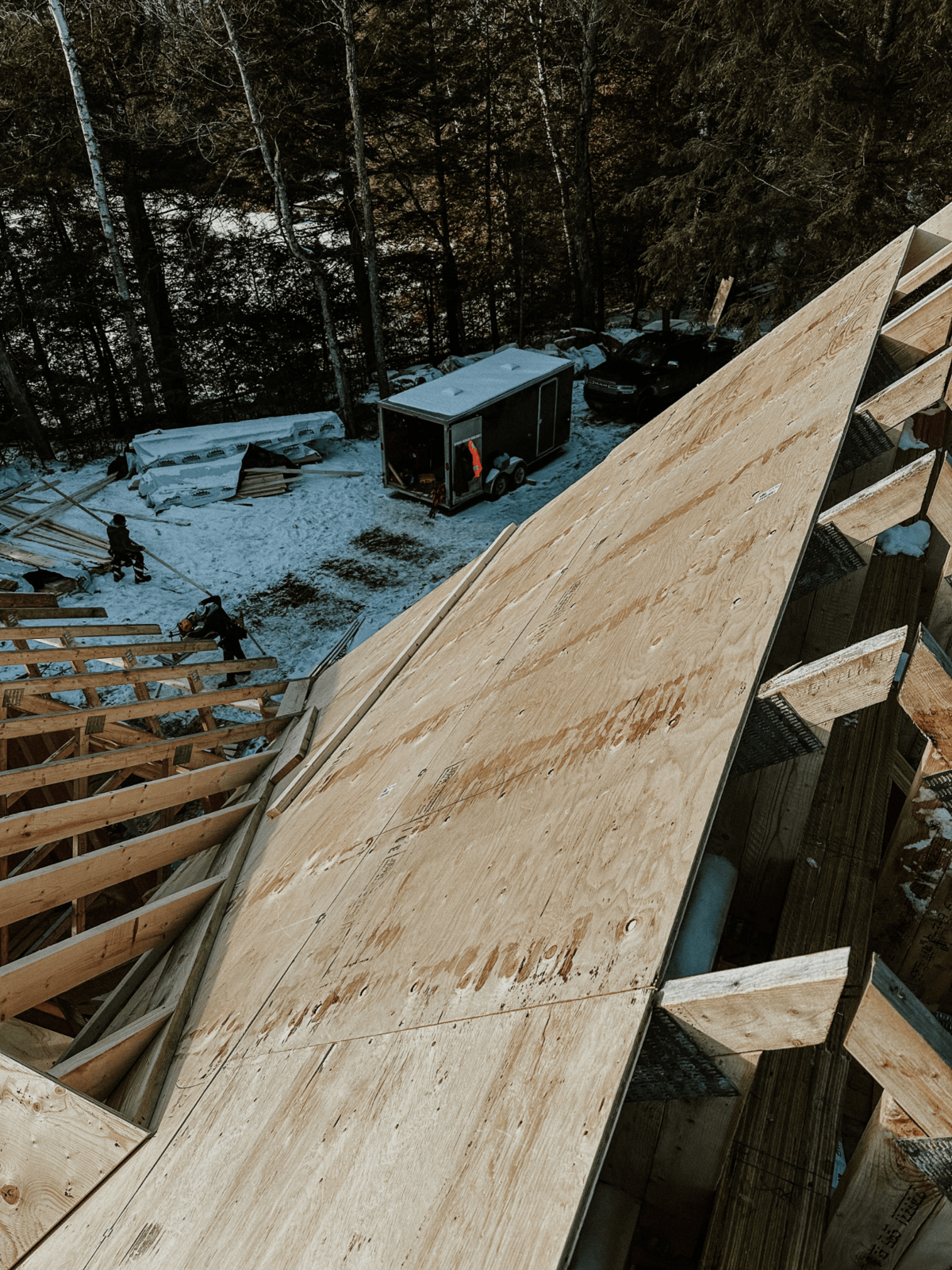 Haliburton Highlands timber home build process showing high ceilings, large beams, and detailed wood joinery.