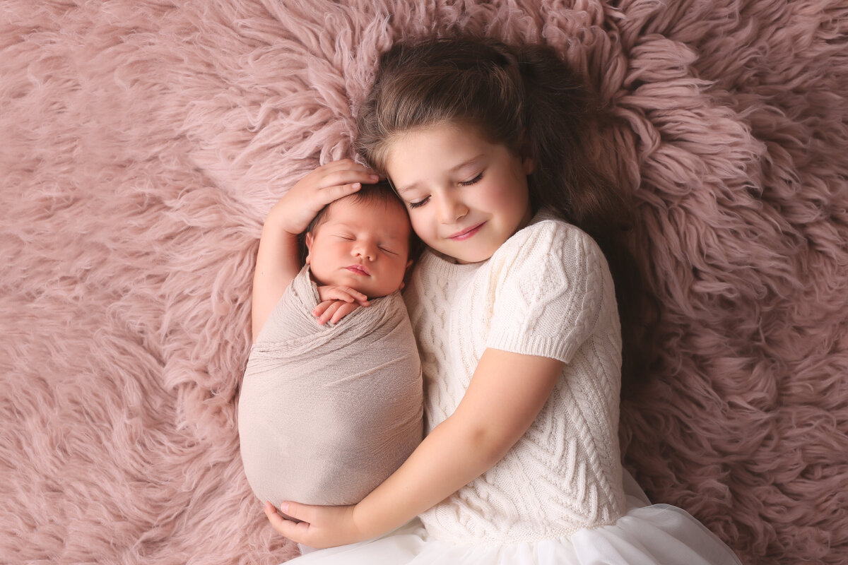 Newborn baby and her sister