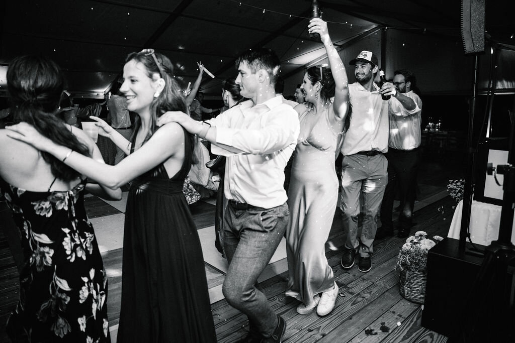 Conga line at wedding in black and white