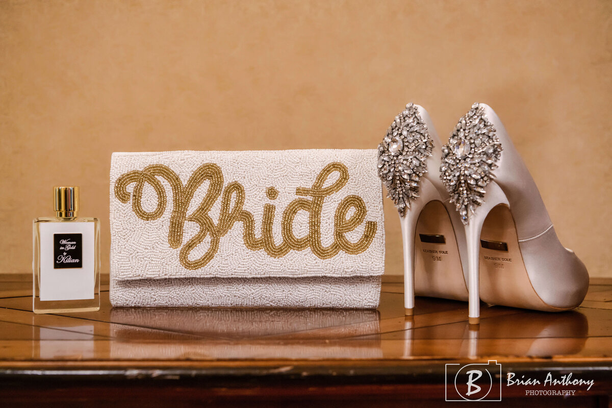 Chic bridal accessories featuring sparkling shoes and a decorative “Bride” sign.