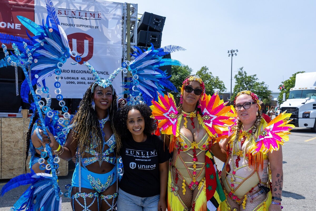 Toronto caribbean carnival parade masquerader in costume with Sunlime Mas, the number 1 medium size band at Toronto Carnival.