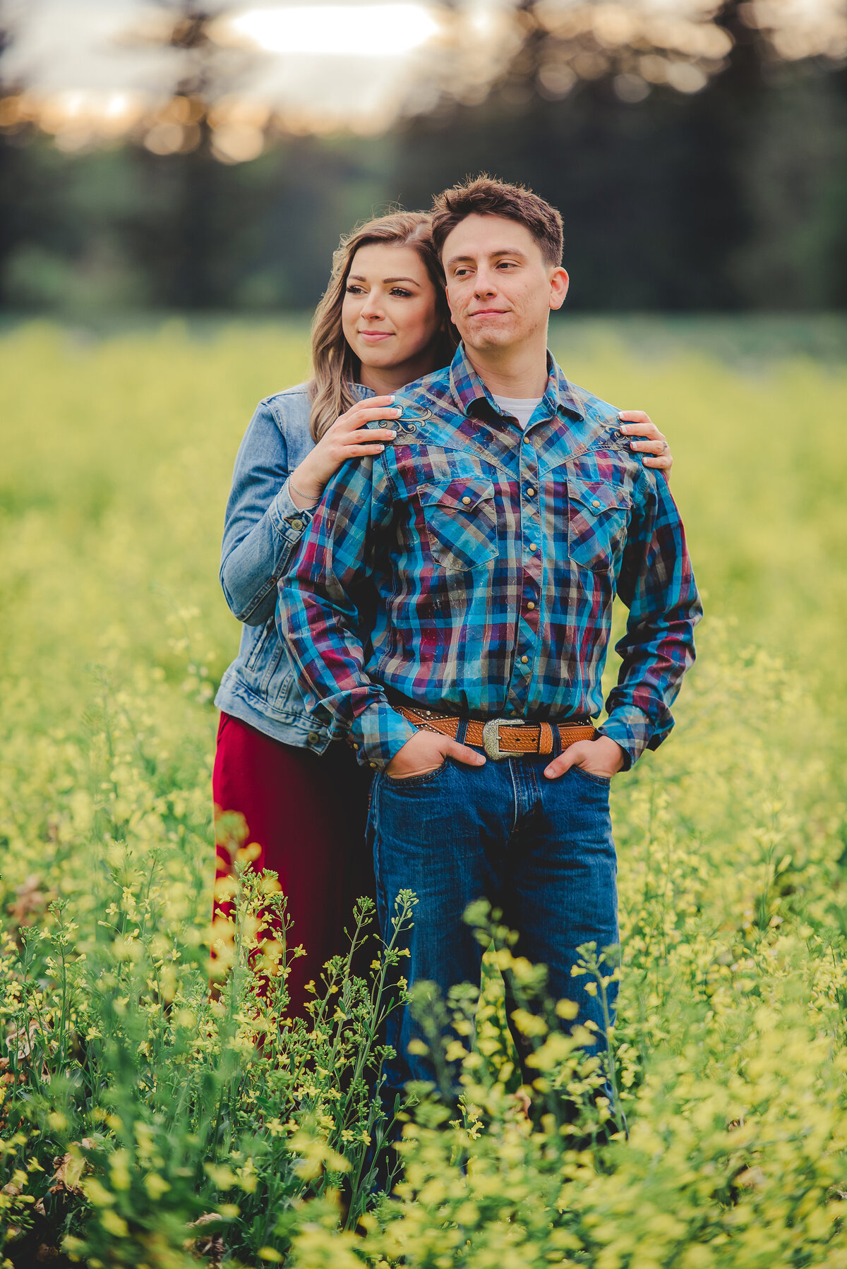 engaged couple in field of flowers