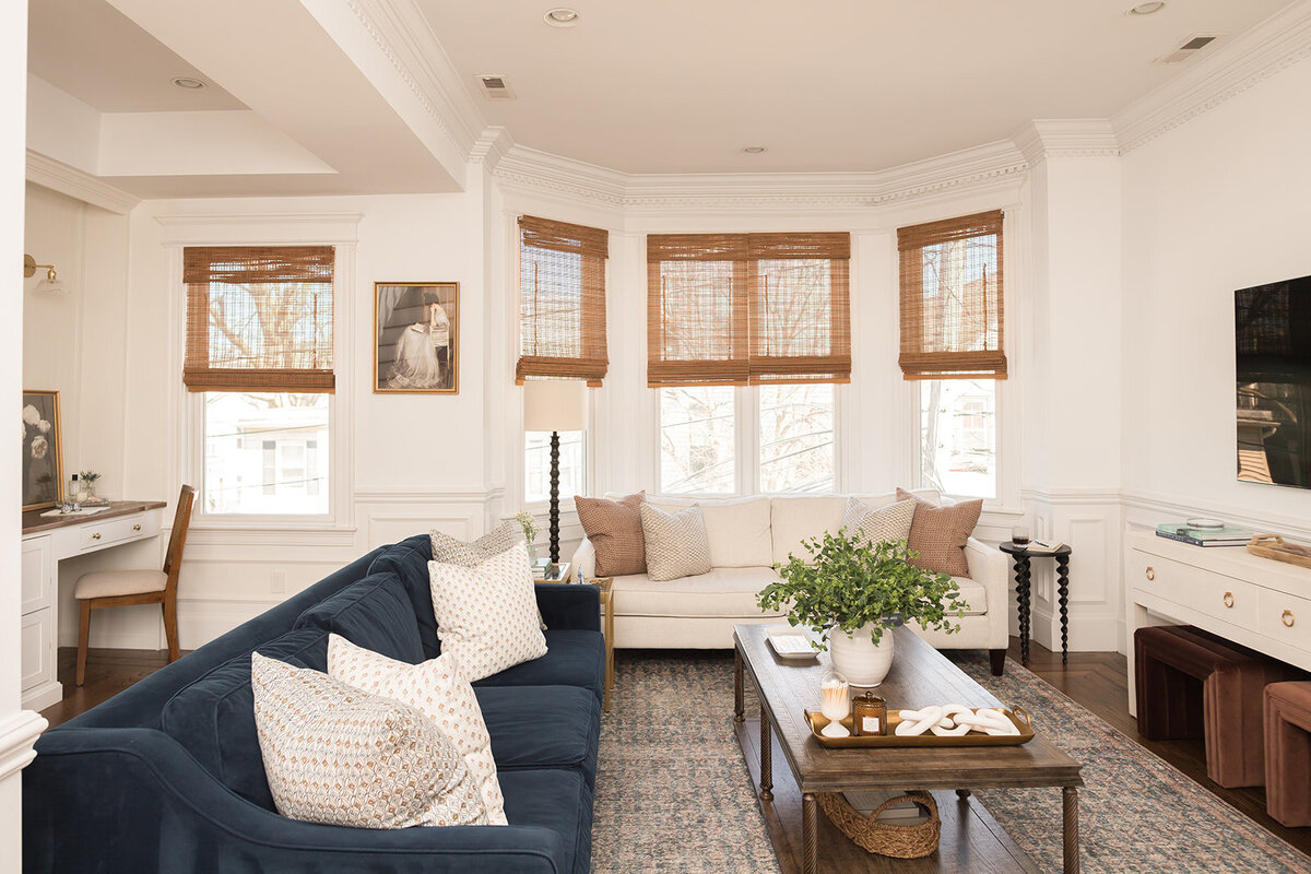 melinda chesson interiors boston living room with large baywindow and blue couch