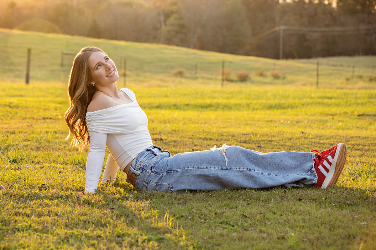 High school senior portrait with golden light and fall foliage at Anne Springs Close Greenway in Fort Mill SC