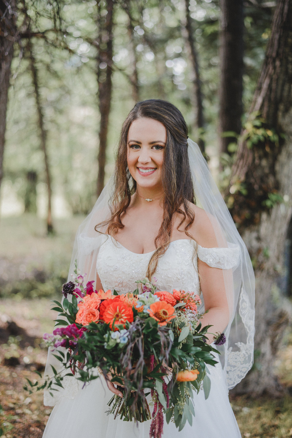 bride holding orange floral bouquet