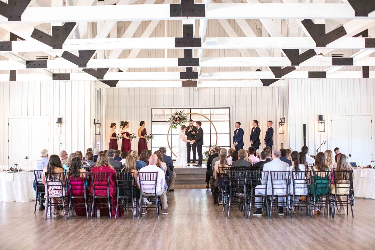 wedding photographer in New Braunfels  captures indoor ceremony at wide angle at Milestone New Braunfels Texas