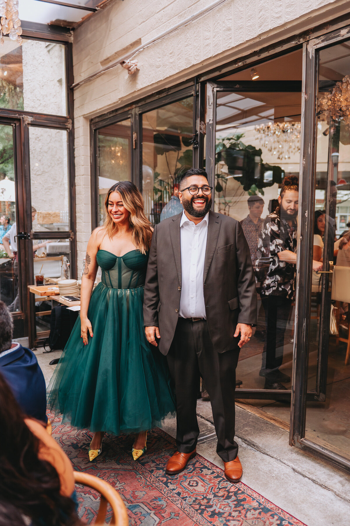 A couple holds hands while smiling