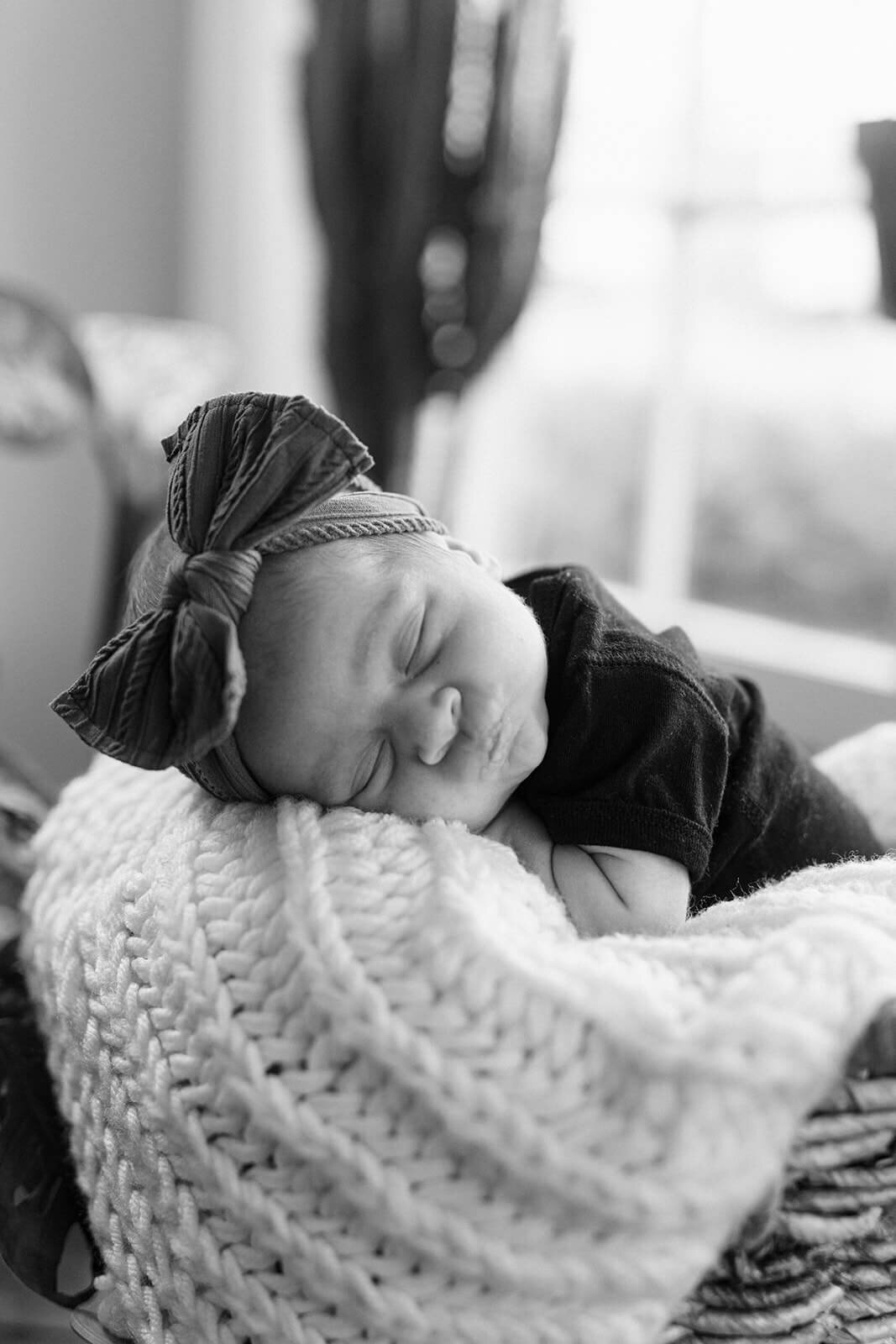close up of baby asleeo on a knitted blanket