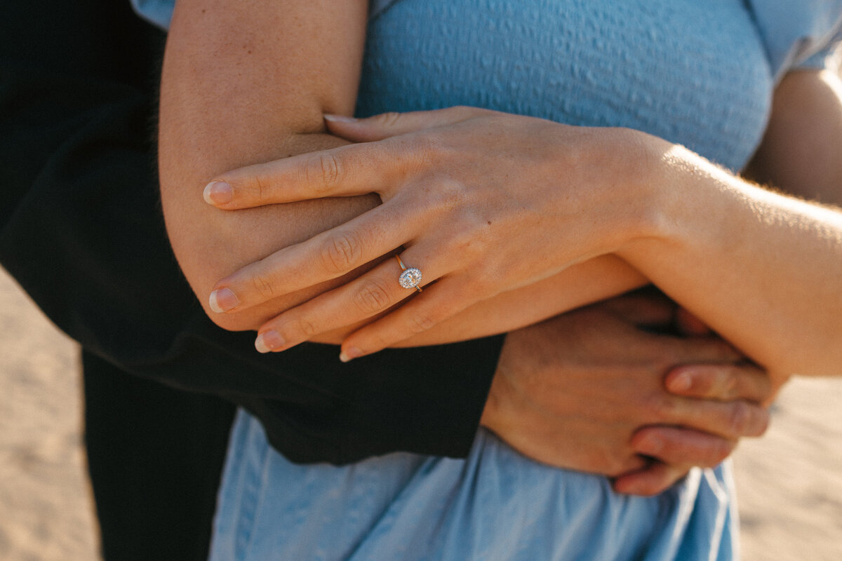 Photograph of a young  engaged couple at the beach in West Cornwall on a sunny day