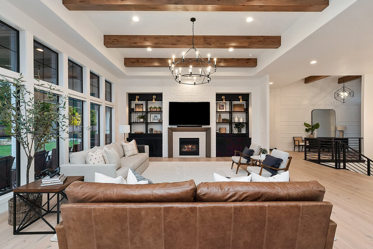 luxury great room with luxury lighting and wooden beams by Idaho luxury custom home builder Thompson Homes