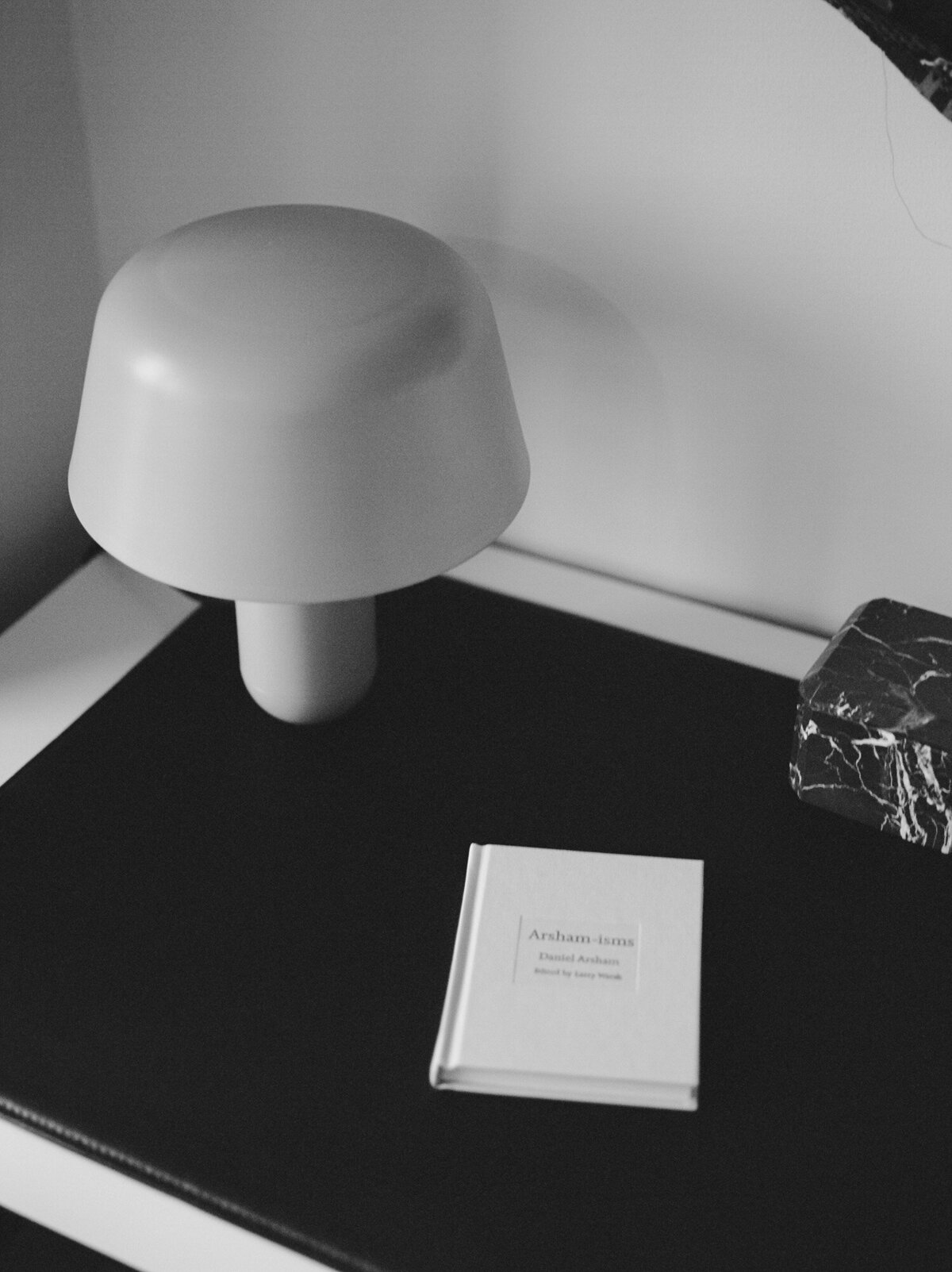clean desk with black pad, modern lamp, book, bed & breakfast in Detroit branding photos